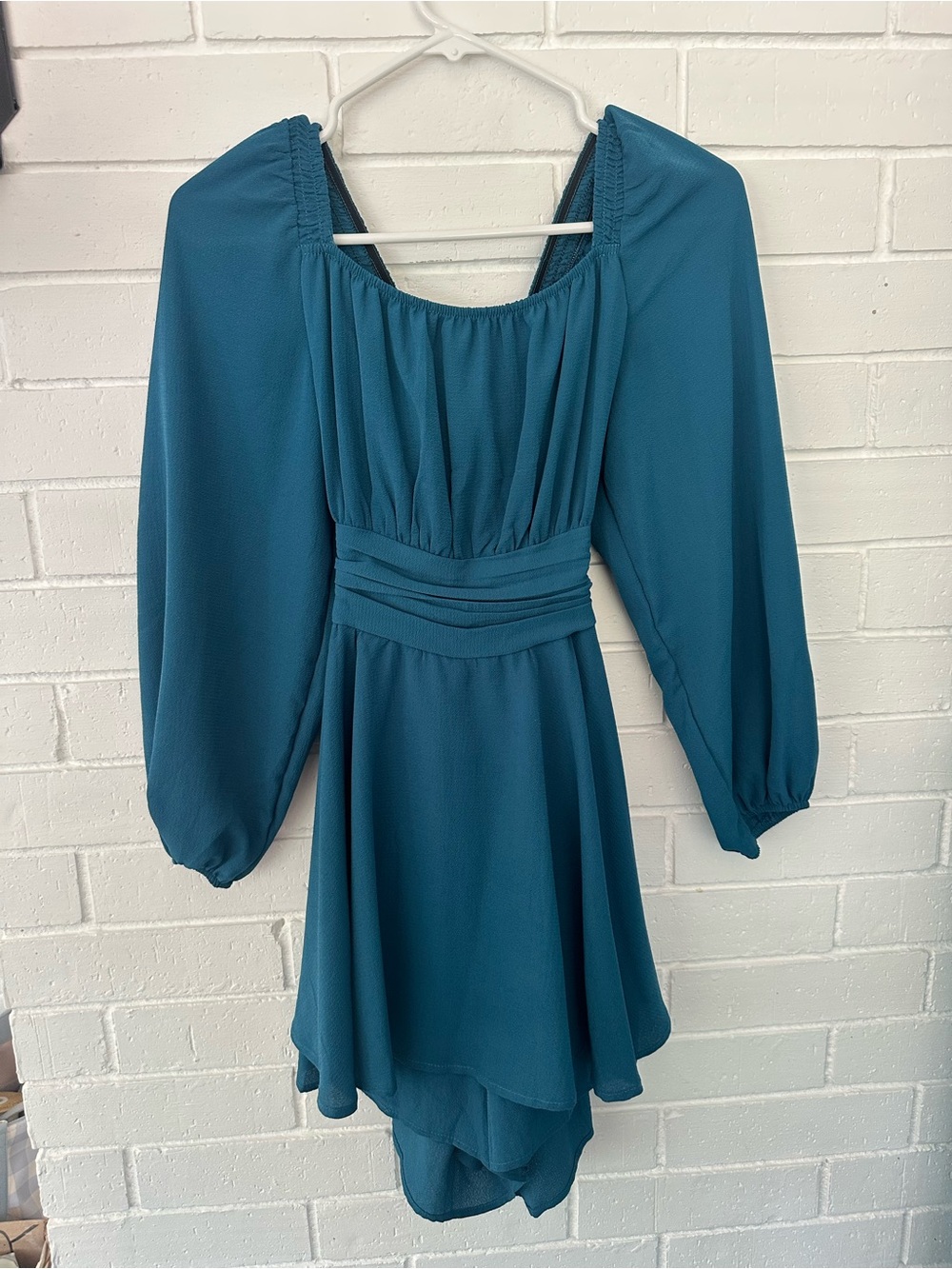 - Teal blue romper with lantern sleeves and tie back detail 
- Size M